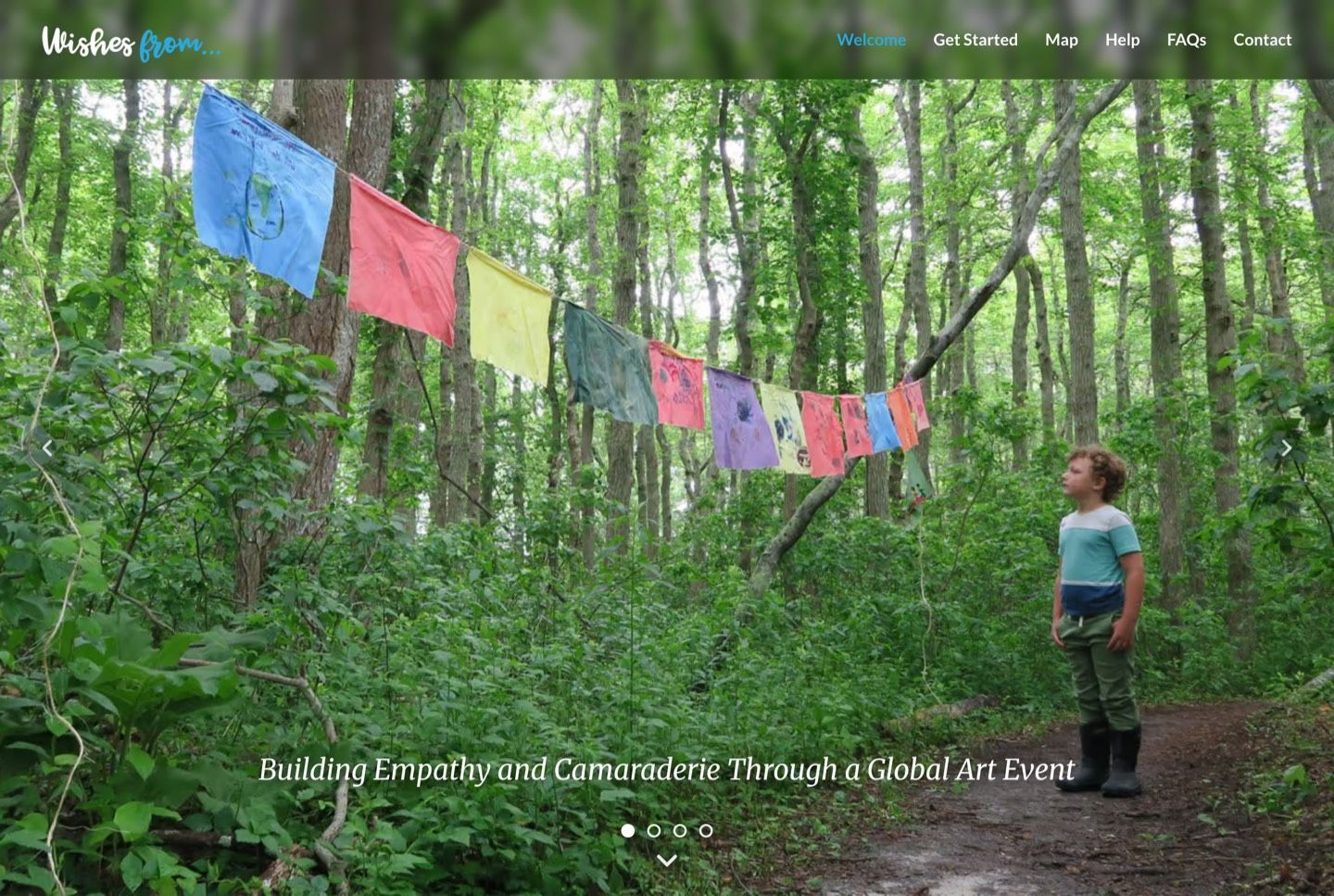 The rebuilt site's home page: a full-width photograph of hand-painted flags strung between trees, with the site's name and navigation across the top.
